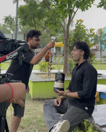 Park shoot: holding up a makhana pouch with a Ronin gimbal in front